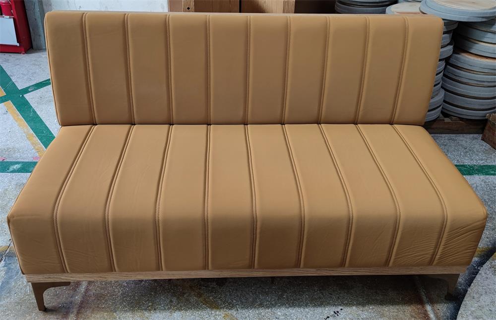 Close-up of restaurant booth sofa’s metal leg design and high-quality upholstery, ideal for hotel lobbies and cafes.