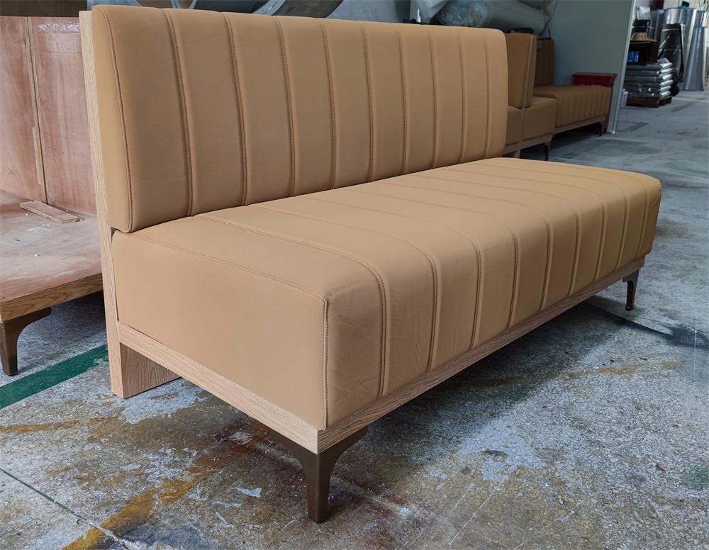 Warm-toned restaurant booth with wood frame and premium fabric, customized for commercial use