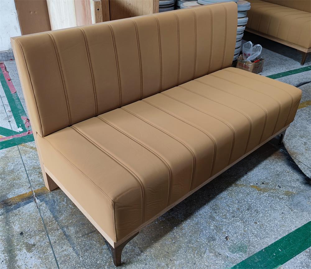 Modern upholstered restaurant booth seating with wood frame and vertical stitching design.