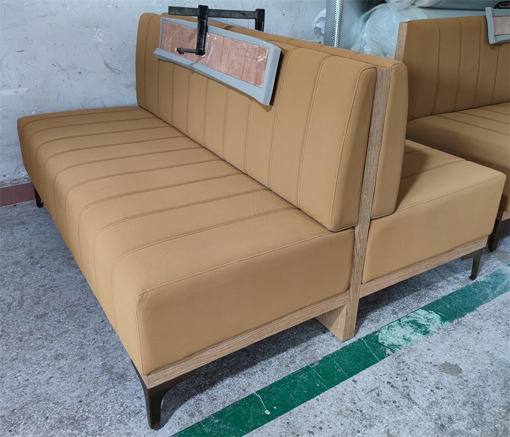 Double-sided upholstered booth seating with sturdy wood frame and metal legs, ideal for hotel and restaurant use.