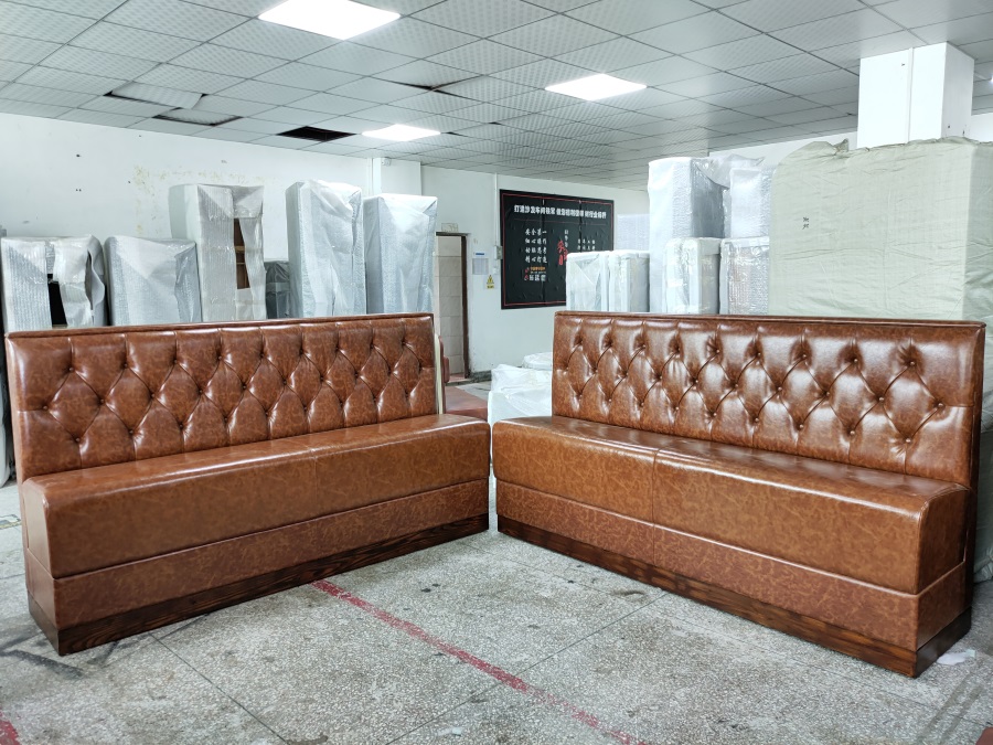 classic button-tufted leather restaurant booth seating.