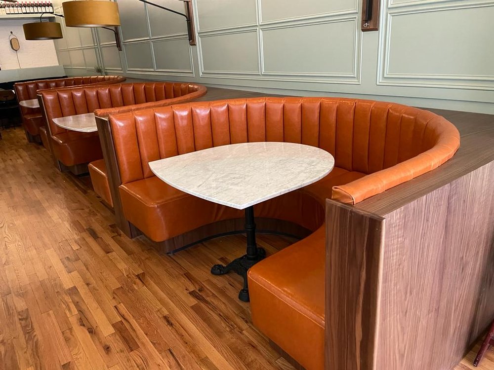 Modern nightclub seating with plush booths and bar stools