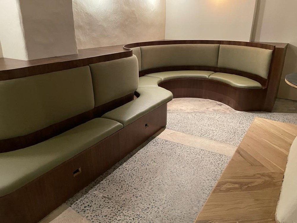 Stylish restaurant corner booth with comfortable seating in a cozy corner.
