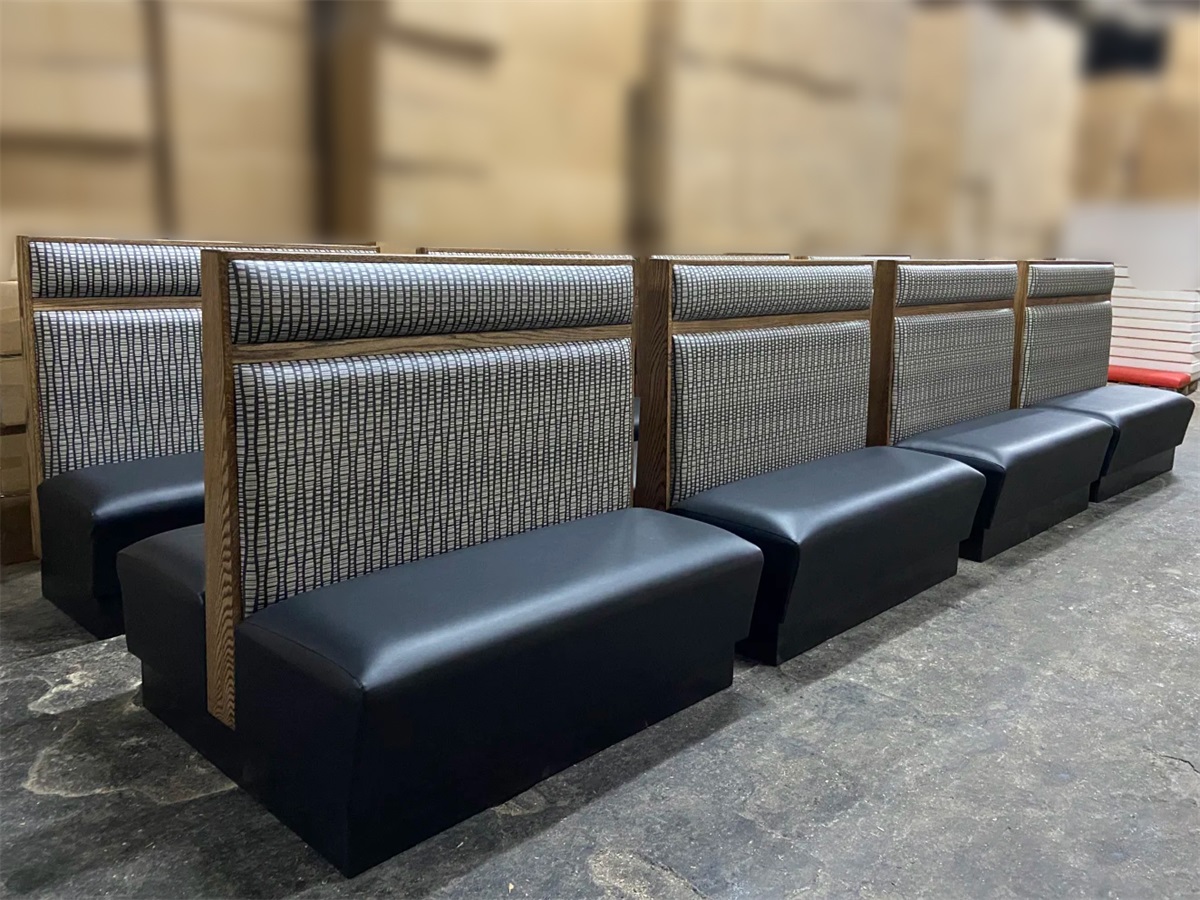 Commercial double-sided upholstered booth with cushioned seat and patterned backrest, ideal for restaurant seating